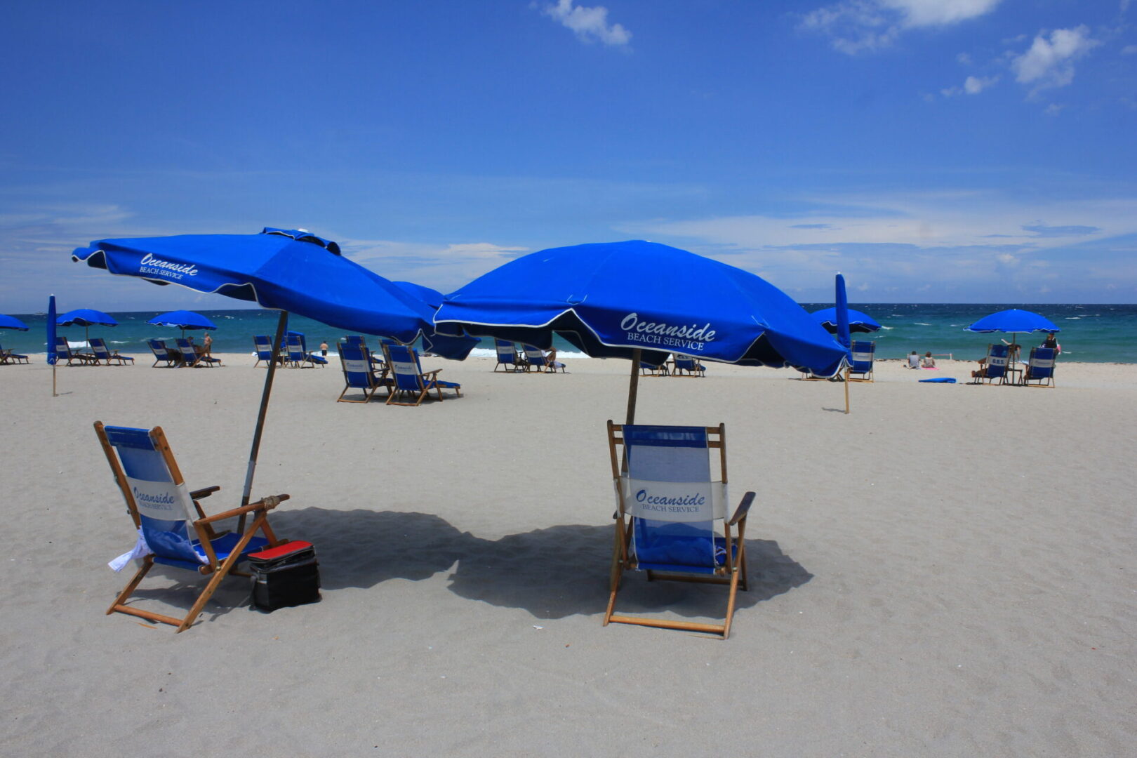 A beach with chairs and umbrellas on it